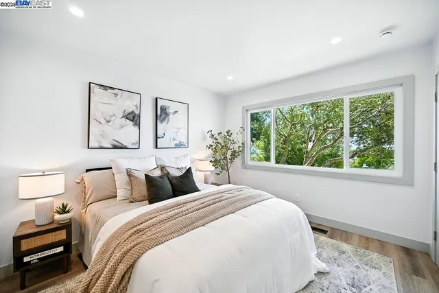 a bedroom with a bed and a large window