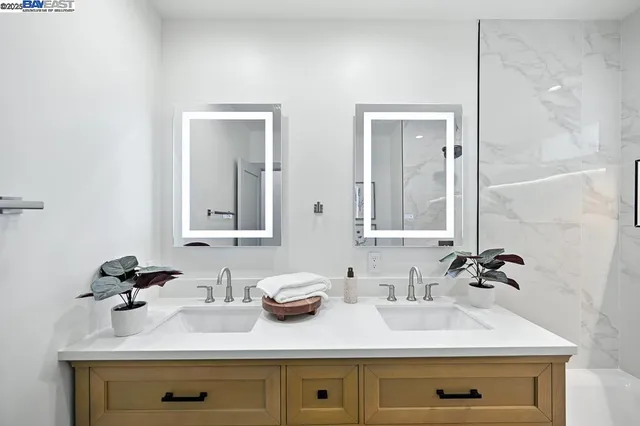 a bathroom with a tub sink and mirror