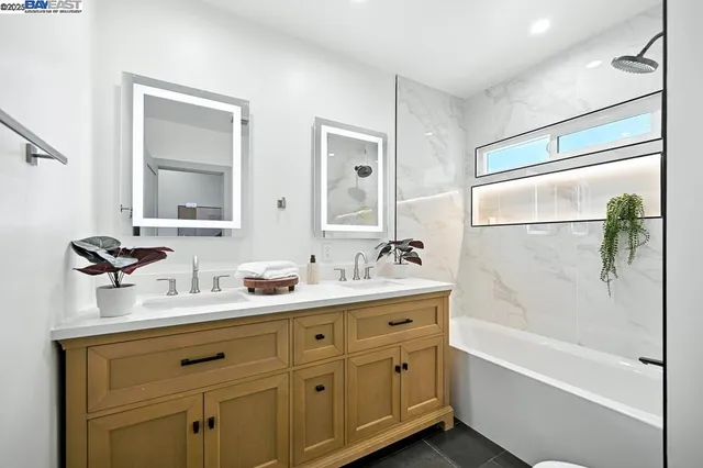 a bedroom with a bed table and a window