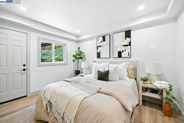 a bedroom with a large bed and a chandelier