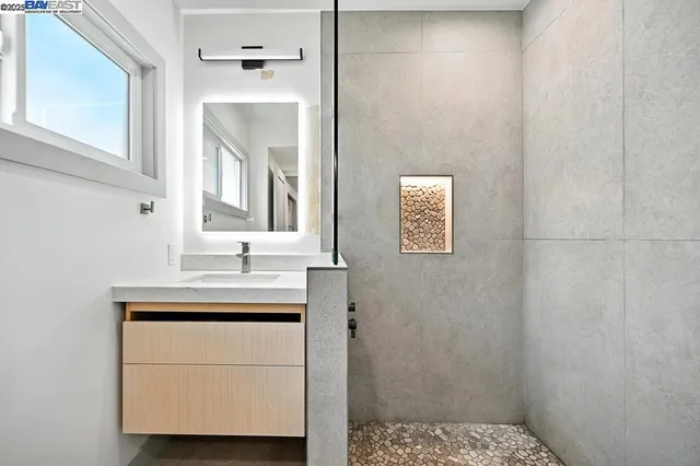 a bathroom with a sink a mirror and a window