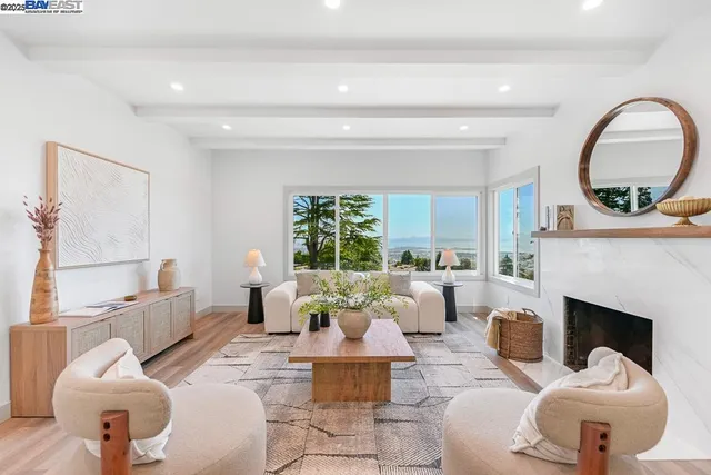 a living room with furniture a fireplace and a large window
