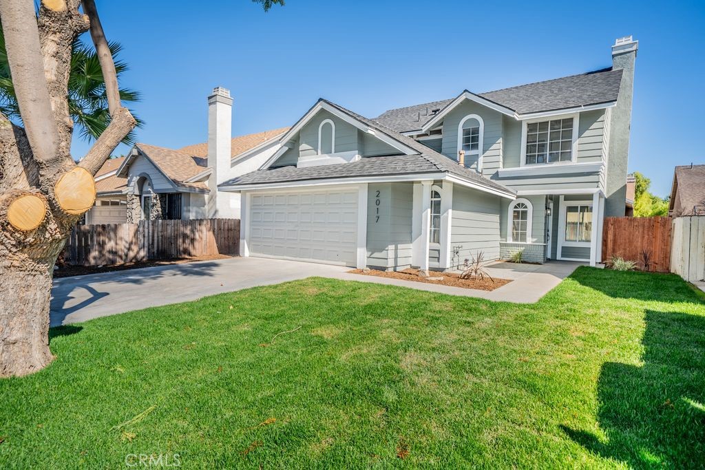 2017 Cherrytree Drive Perris, CA 92571 - Photo 19 of 20 a front view of a house with yard and green space
