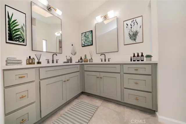 a bathroom with a double vanity sink mirror and