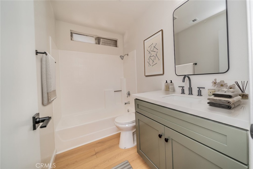 2017 Cherrytree Drive Perris, CA 92571 - Photo 8 of 20 a bathroom with a granite countertop sink a toilet and a mirror