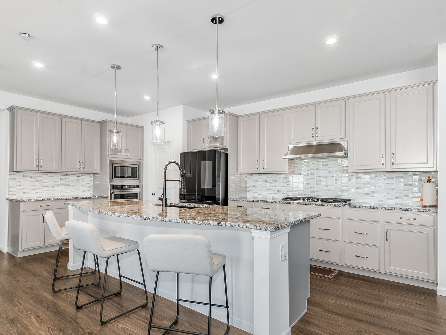 2552 Weatherbee Lane Naperville, IL 60563 - Photo 8 of 43 a kitchen with stainless steel appliances granite countertop a stove top oven a refrigerator a sink and white cabinets with wooden floor