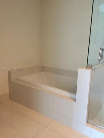 a bath tub sitting next to a white sink