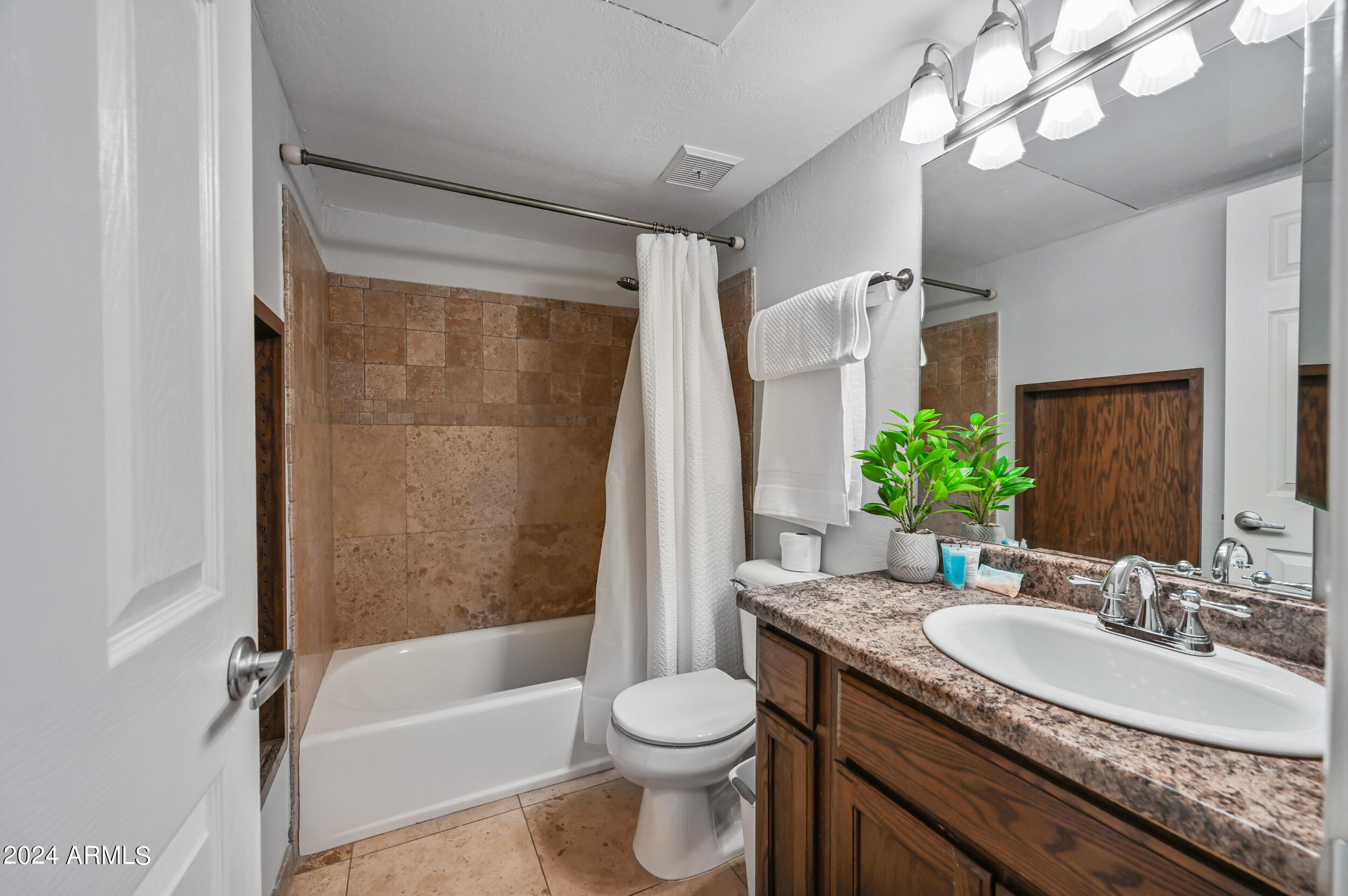 357 East Thomas Road, Unit A208 Phoenix, AZ 85012 - Photo 25 of 36 a bathroom with a granite countertop sink toilet and shower