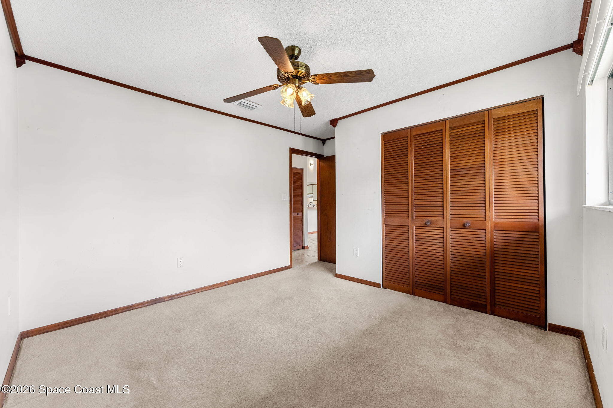 3121 Kirkland Road Northeast Palm Bay, FL 32905 - Photo 31 of 52 an empty room with ceiling fan and window