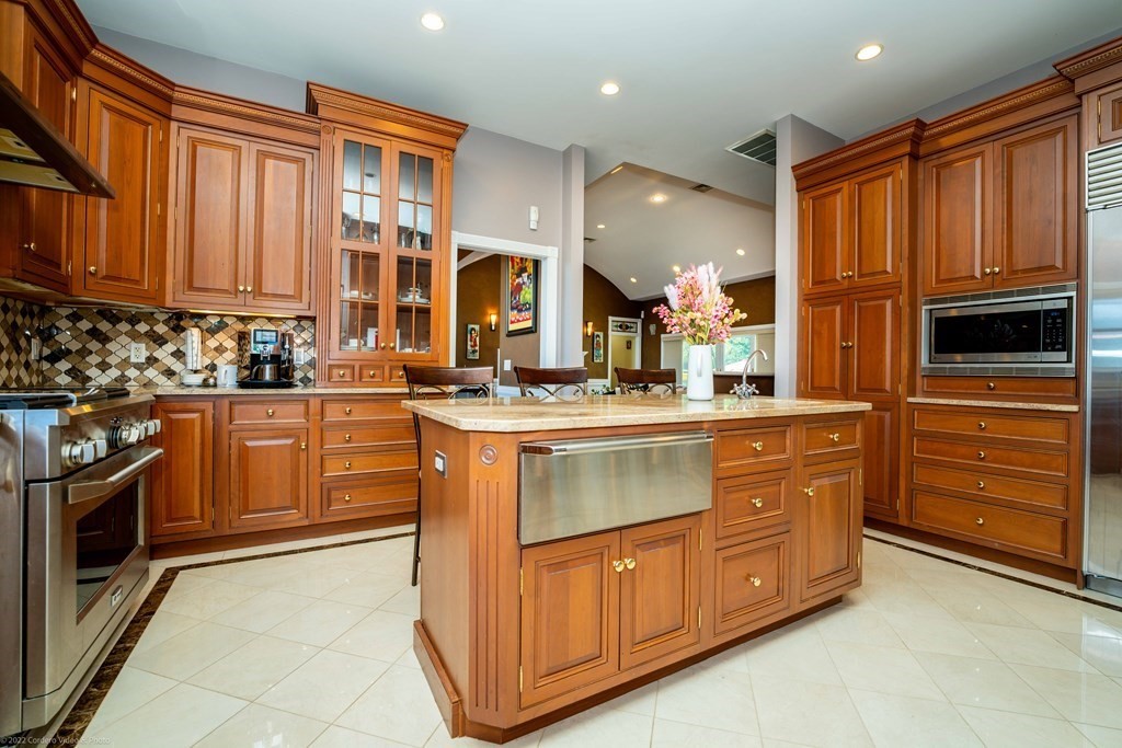 93 Narrows Road Assonet, MA 02702 - Photo 11 of 42 a kitchen with stainless steel appliances granite countertop a stove a sink and a refrigerator