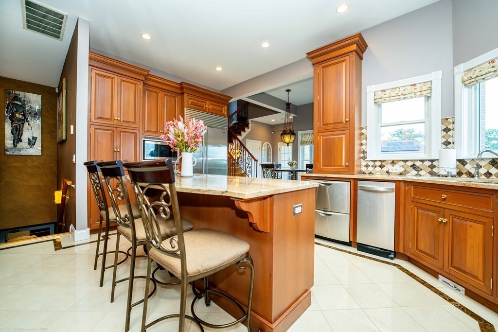 93 Narrows Road Assonet, MA 02702 - Photo 13 of 42 a dining hall with stainless steel appliances granite countertop a stove a sink and a refrigerator