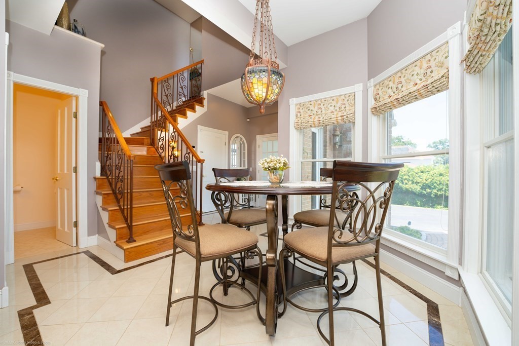 93 Narrows Road Assonet, MA 02702 - Photo 14 of 42 a view of a dining room with furniture a chandelier and a large window