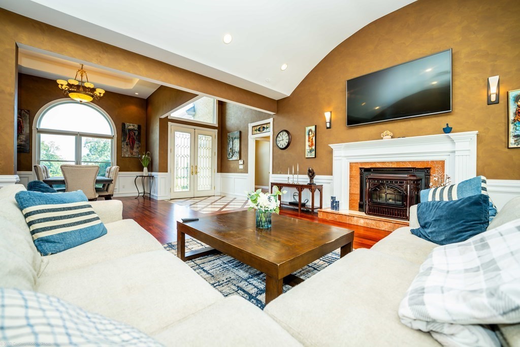93 Narrows Road Assonet, MA 02702 - Photo 17 of 42 a living room with furniture a flat screen tv and a fireplace