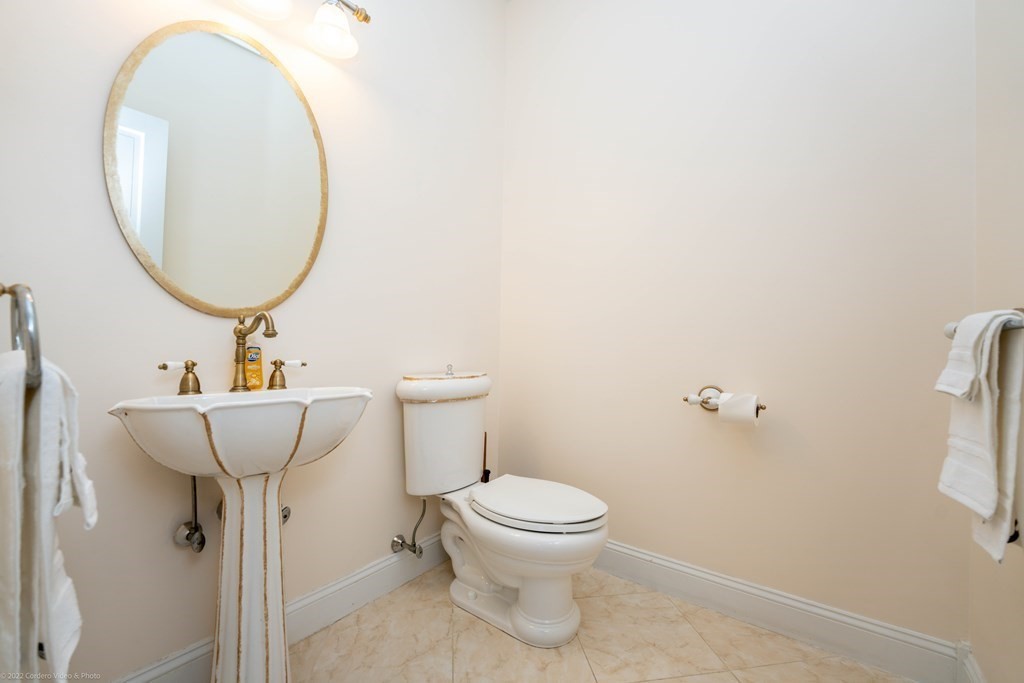 93 Narrows Road Assonet, MA 02702 - Photo 22 of 42 a bathroom with a toilet sink and mirror
