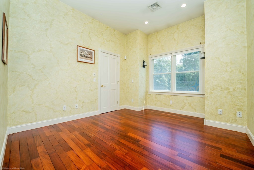 93 Narrows Road Assonet, MA 02702 - Photo 29 of 42 a view of empty room with wooden floor and fan