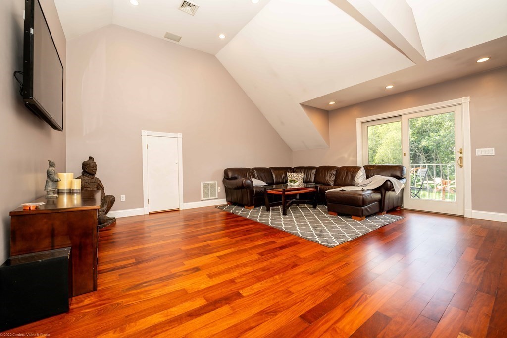 93 Narrows Road Assonet, MA 02702 - Photo 32 of 42 a living room with furniture and a flat screen tv
