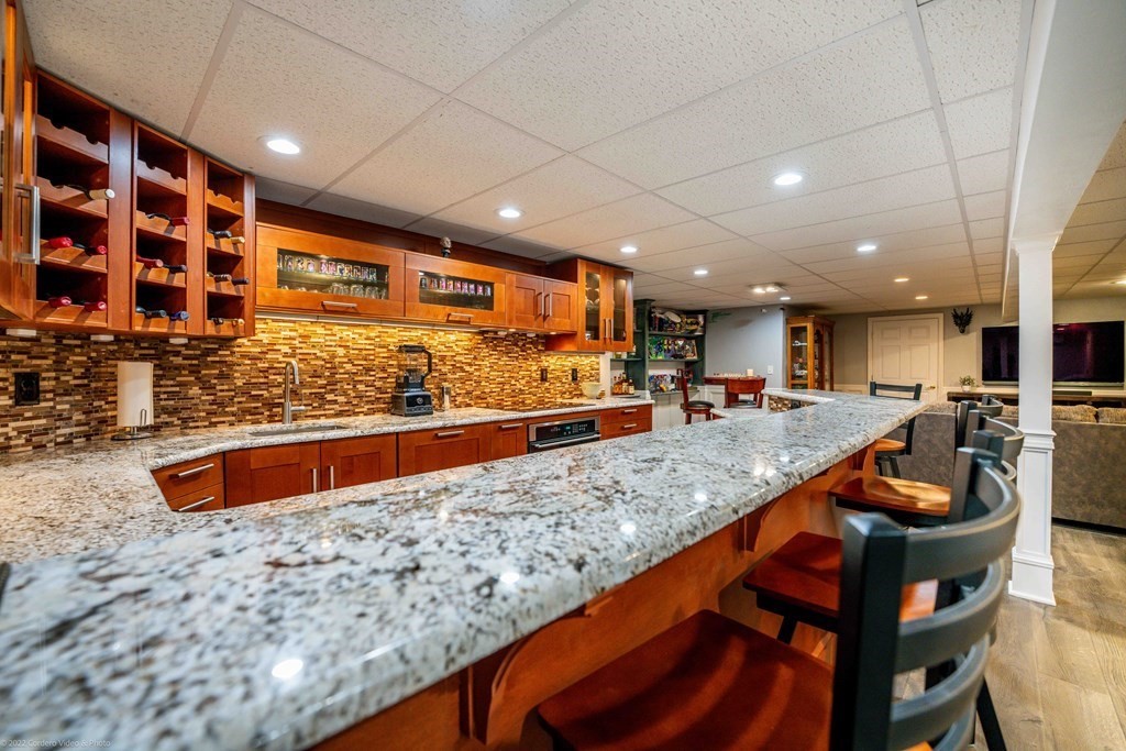 93 Narrows Road Assonet, MA 02702 - Photo 38 of 42 a kitchen with stainless steel appliances granite countertop a sink and a counter top space