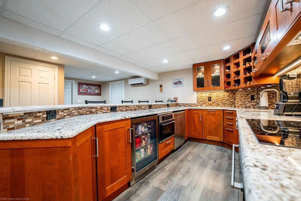 93 Narrows Road Assonet, MA 02702 - Photo 40 of 42 a large kitchen with stainless steel appliances granite countertop a stove and a sink