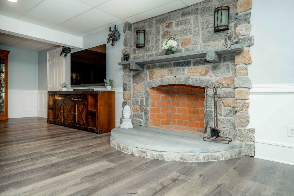 93 Narrows Road Assonet, MA 02702 - Photo 42 of 42 a living room with fireplace and flat screen tv