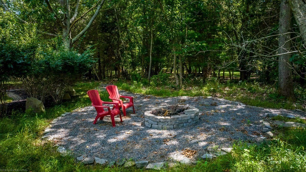 93 Narrows Road Assonet, MA 02702 - Photo 10 of 42 a backyard of a house with table and chairs