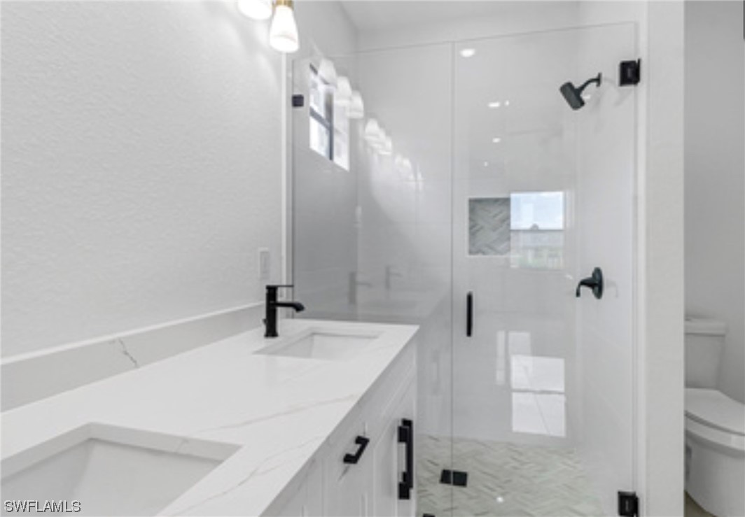 2607 4th Street Southwest Lehigh Acres, FL 33976 - Photo 15 of 21 a bathroom with a sink a toilet and shower