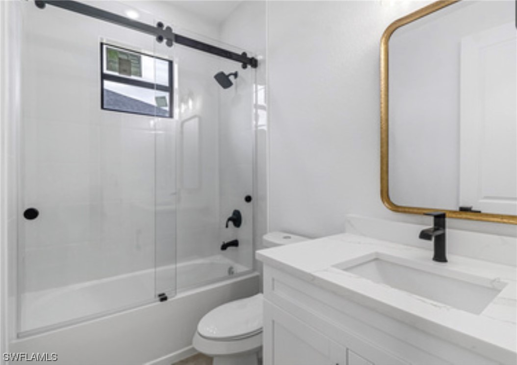 2607 4th Street Southwest Lehigh Acres, FL 33976 - Photo 17 of 21 a bathroom with a sink a toilet a mirror and shower