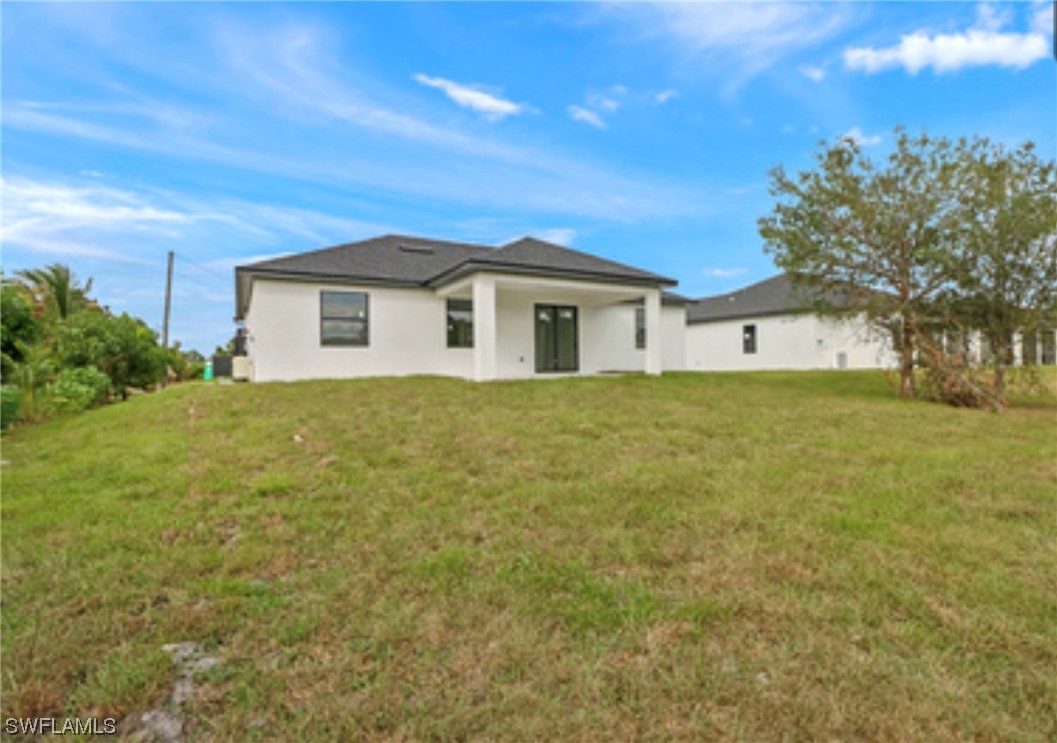 2607 4th Street Southwest Lehigh Acres, FL 33976 - Photo 21 of 21 a view of a house with a yard