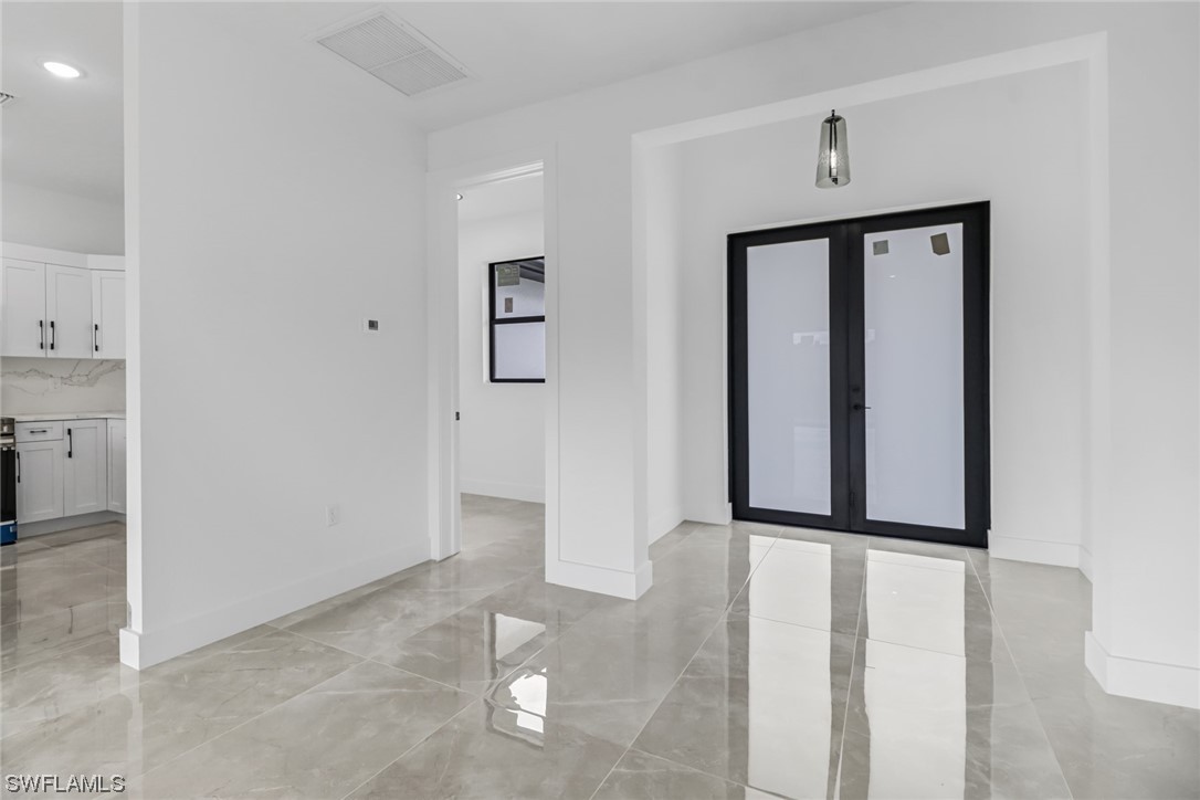 2607 4th Street Southwest Lehigh Acres, FL 33976 - Photo 7 of 21 an empty room with windows