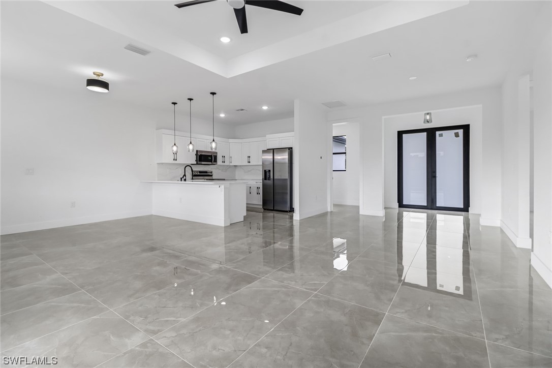 2607 4th Street Southwest Lehigh Acres, FL 33976 - Photo 9 of 21 a view of a kitchen with a refrigerator and microwave