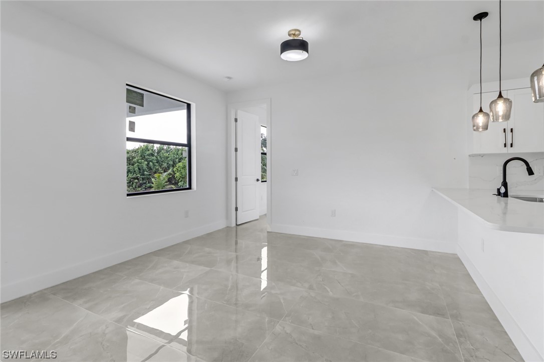 2607 4th Street Southwest Lehigh Acres, FL 33976 - Photo 10 of 21 a view of a room with rack on the wall