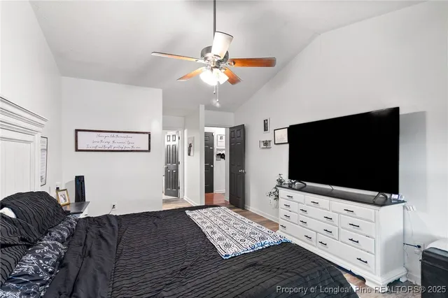 a bedroom with furniture and a flat screen tv