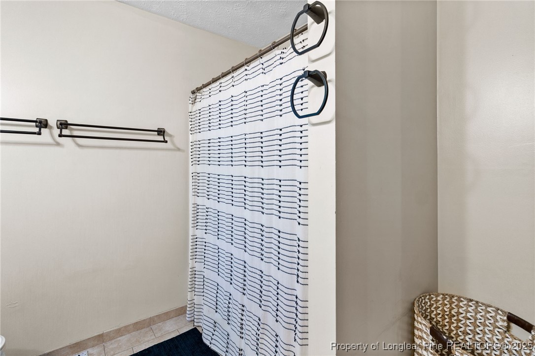 4213 Buckhurst Drive Hope Mills, NC 28348 - Photo 17 of 27 a bathroom with a shower and a window