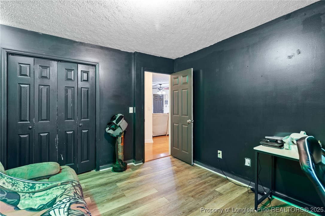 4213 Buckhurst Drive Hope Mills, NC 28348 - Photo 19 of 27 a bedroom with a bed and a chandelier