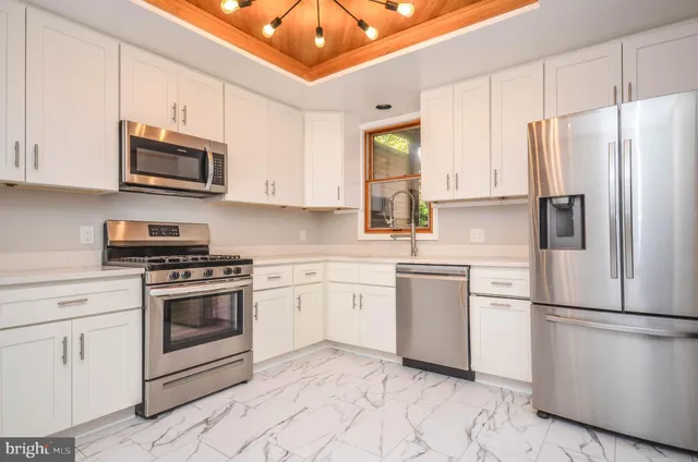 a kitchen with stainless steel appliances granite countertop a refrigerator sink and cabinets