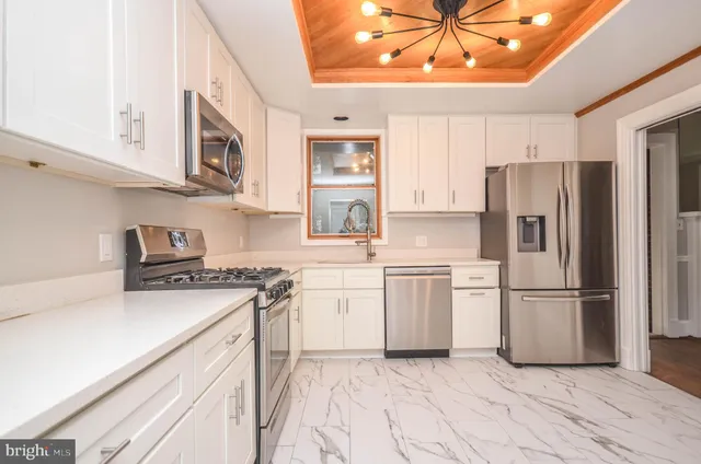 a kitchen with stainless steel appliances a refrigerator and a sink