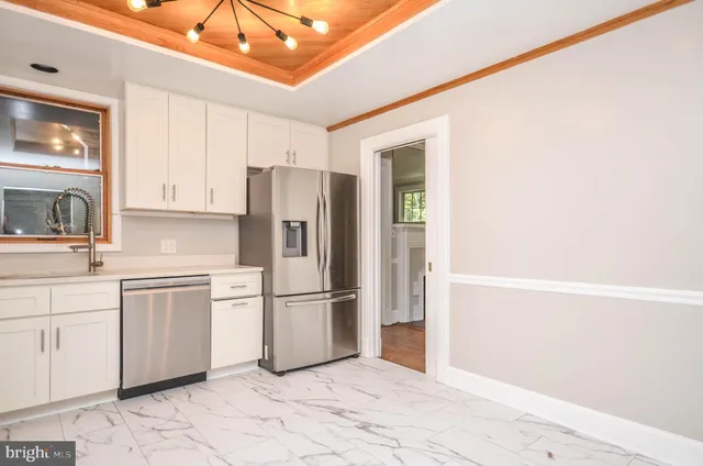 a kitchen with cabinets stainless steel appliances and window