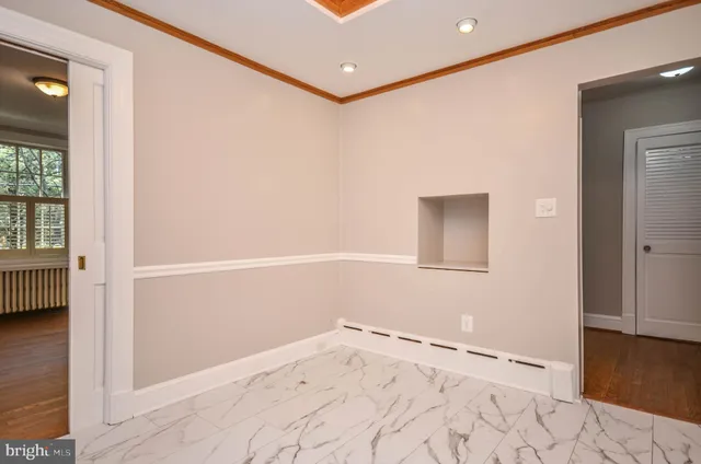 a view of an empty room with a fireplace and a window