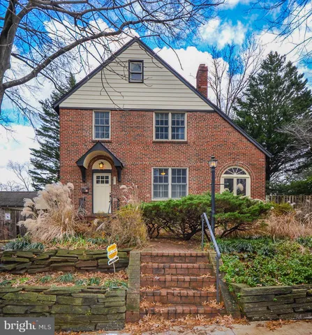 a front view of a house with a yard garage and outdoor seating