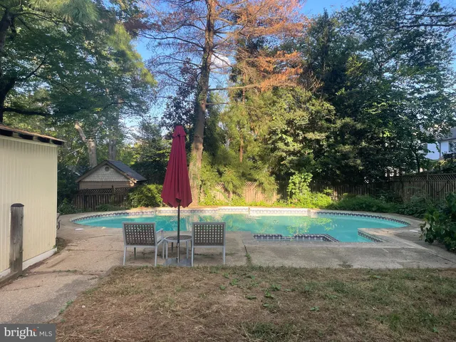 a view of a backyard with swimming pool