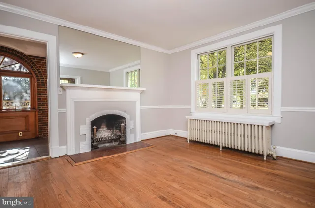 a view of a livingroom with a fireplace and window