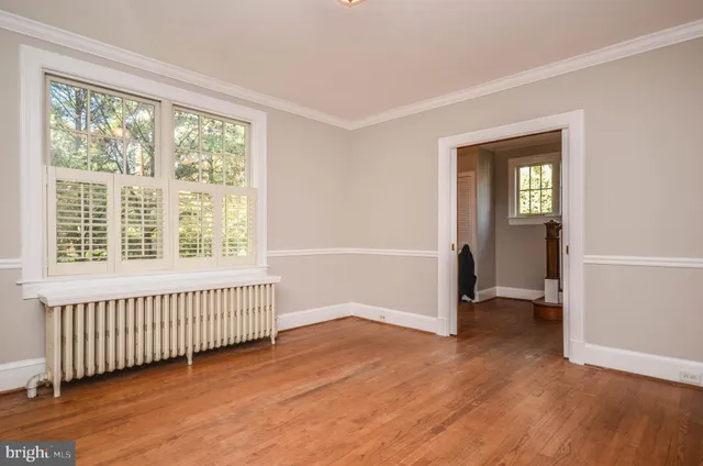 a kitchen with cabinets stainless steel appliances and a window