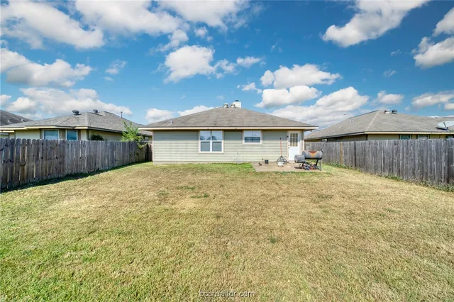 a view of a house with a backyard