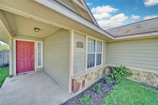 a view of a porch with wooden walls