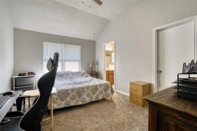 a bedroom with a bed and a desk