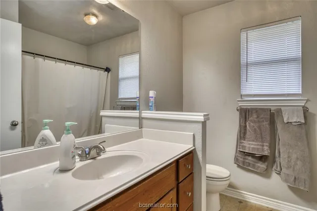 a bathroom with a sink toilet vanity and tub