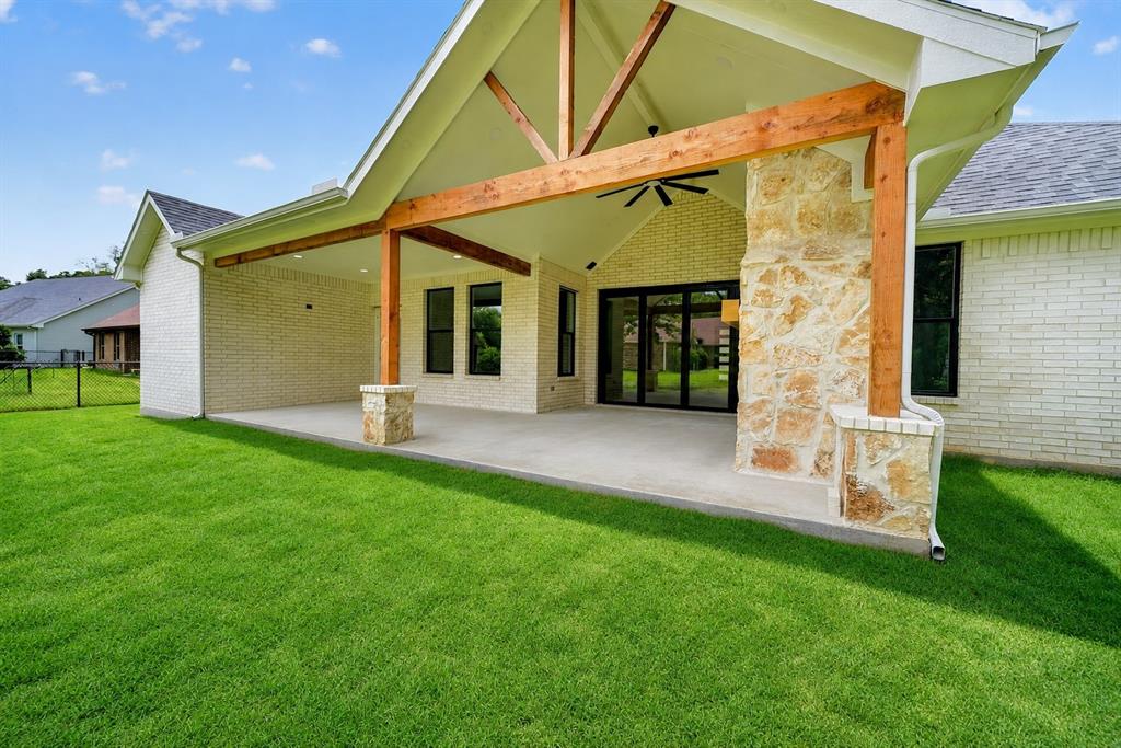 120 Springwood Road Enchanted Oaks, TX 75156 - Photo 33 of 37 Expansive concrete patio featuring a vaulted ceiling with exposed wood beams and a ceiling fan