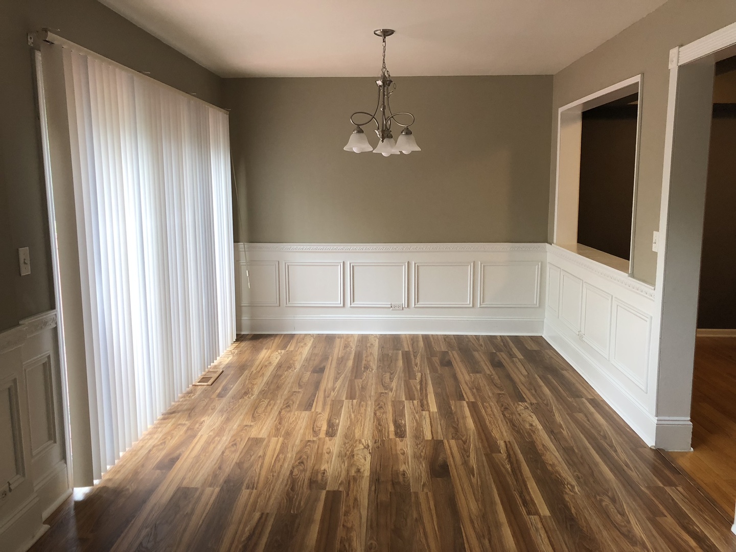 3005 Crystal Rock Road Naperville, IL 60564 - Photo 9 of 31 a view of an empty room with wooden floor and a window