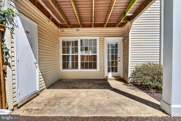a view of a house with backyard porch and wooden fence