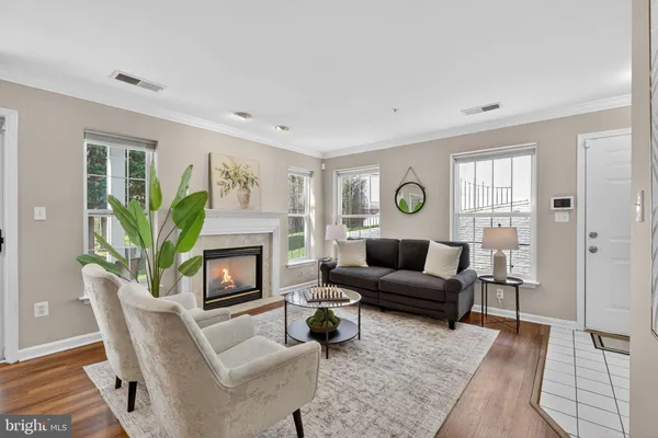 a kitchen with stainless steel appliances granite countertop a stove a sink dishwasher and a refrigerator with wooden floor