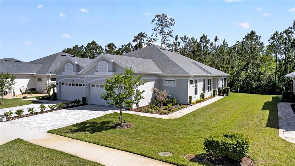 66 Wrendale Loop Ormond Beach, FL 32174 - Photo 2 of 88 a front view of house with yard and trees in the background